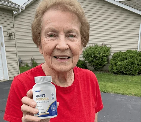 Quiet Nerves user holding the sensibly dosed nerve health support bottle outdoors
